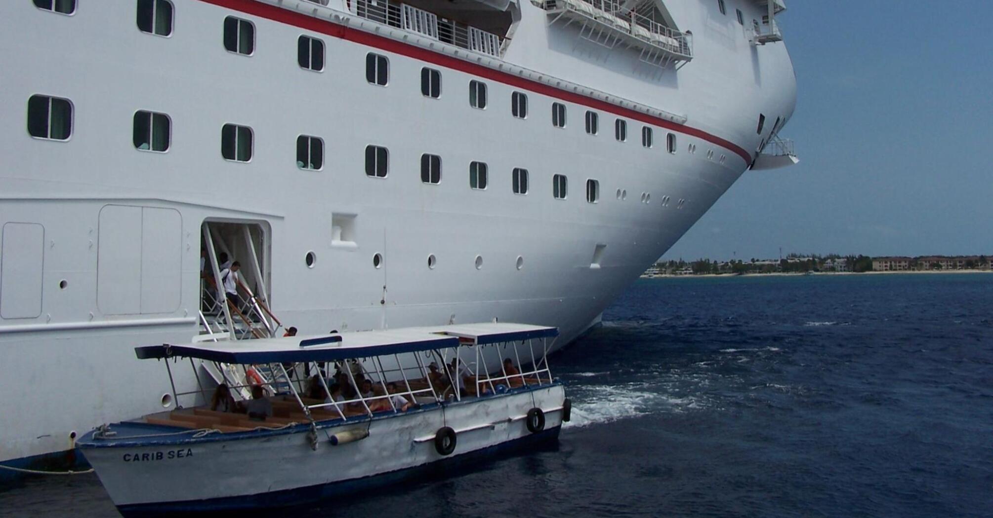 Cruise ship Carnival and a small boat Carib Sea