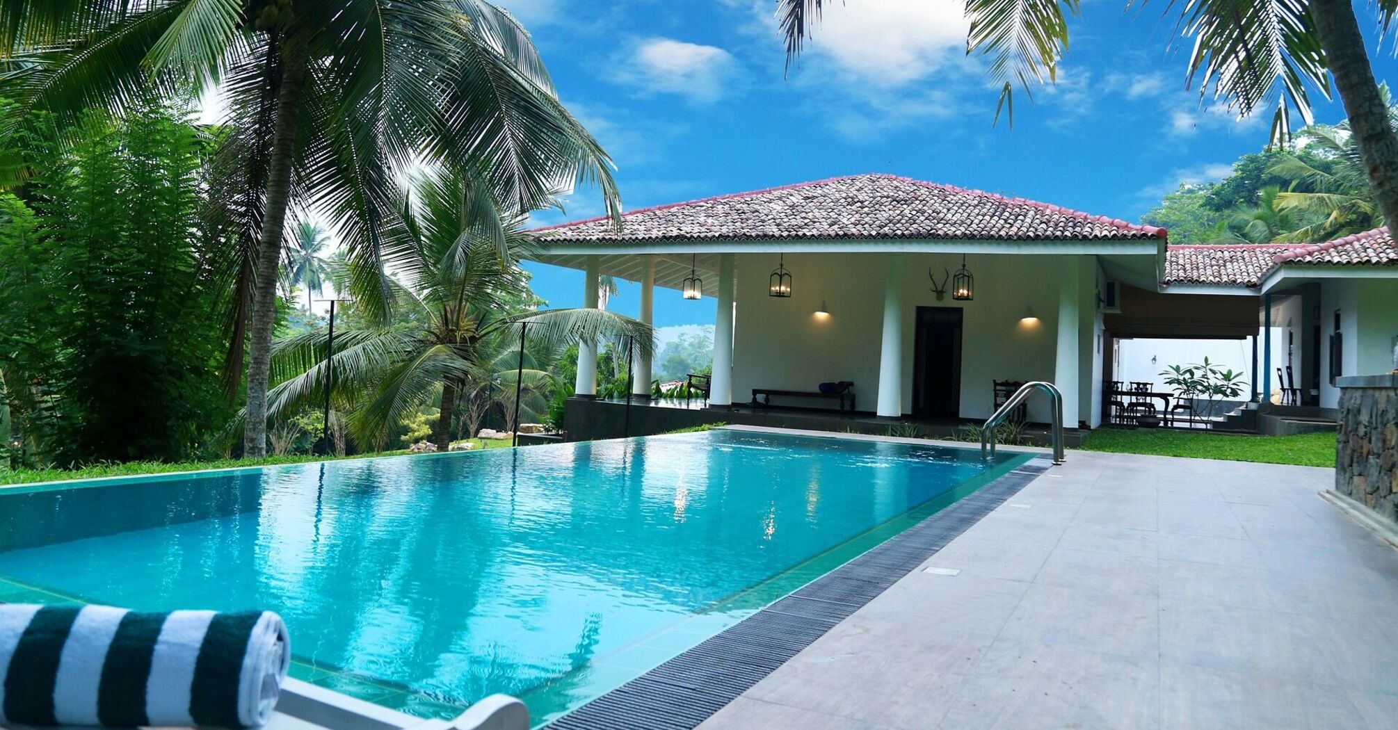 Luxury hotel with a small pool among palm trees