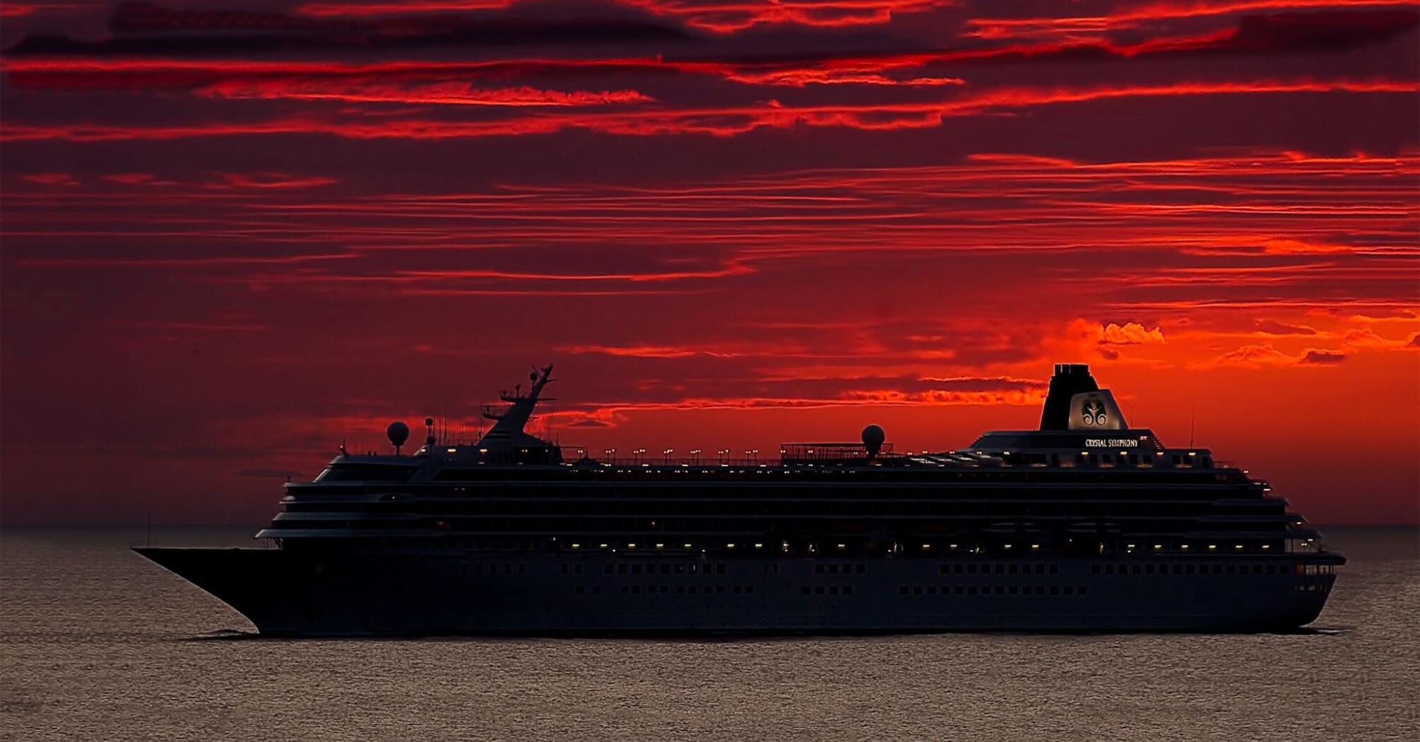 Cruise ship against the backdrop of red sunset