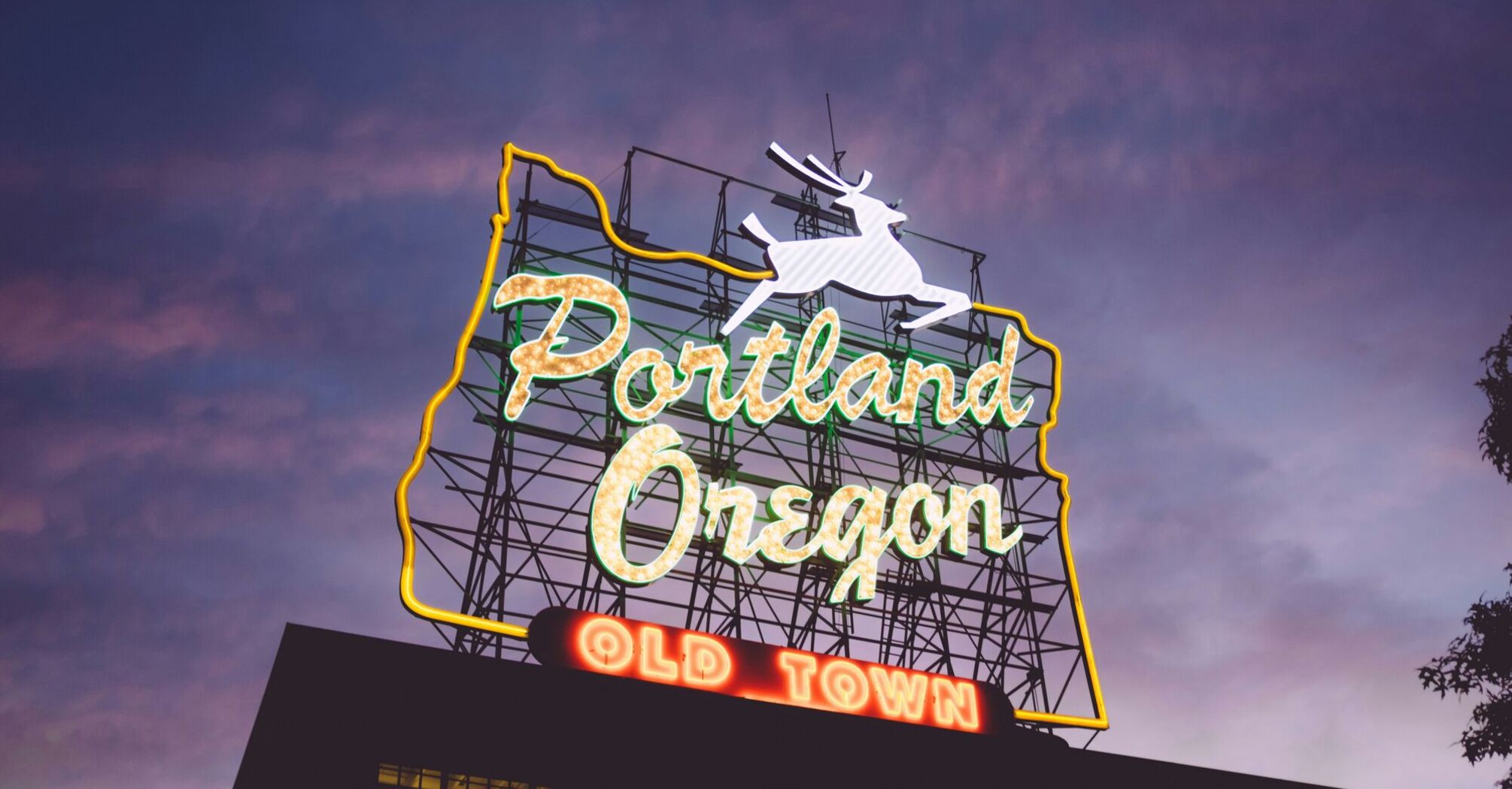 The iconic Portland Oregon Old Town neon sign illuminated at twilight