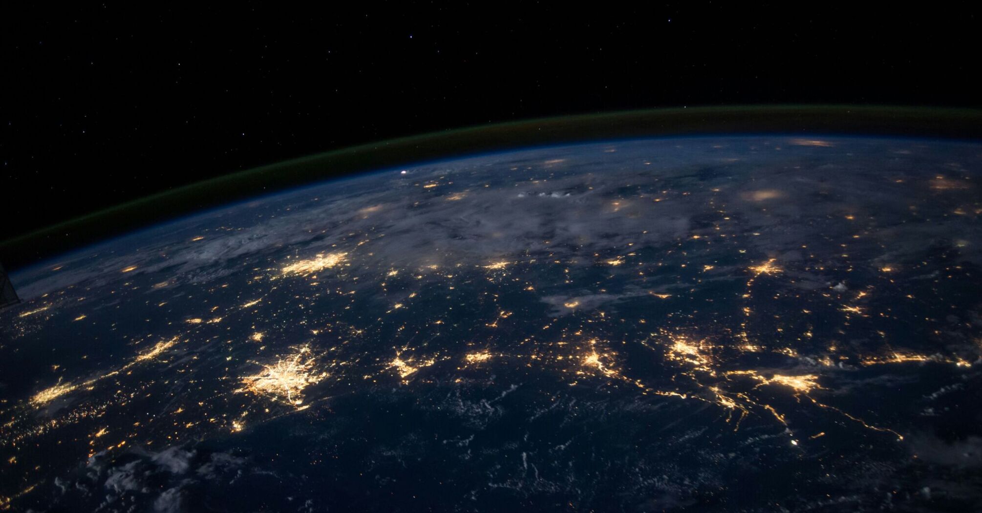 View of Earth from space showing continents illuminated by city lights at night