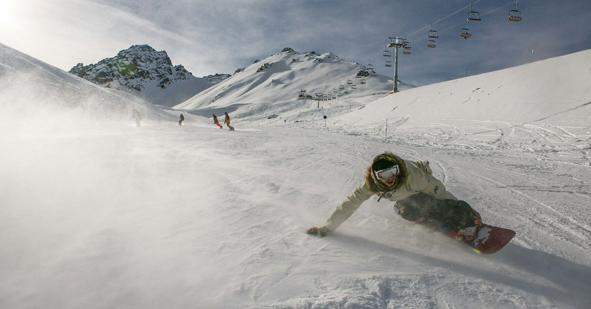 Snowboarder descends down the ski slope, Kazakhstan