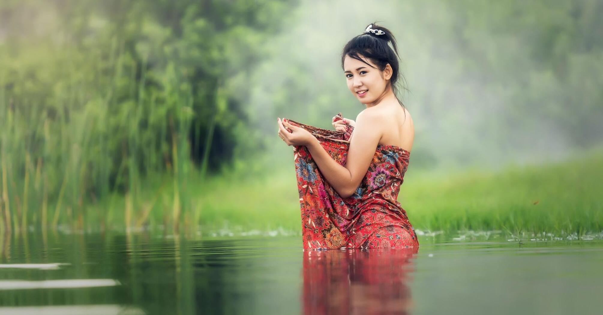 Woman standing in the middle of a pond