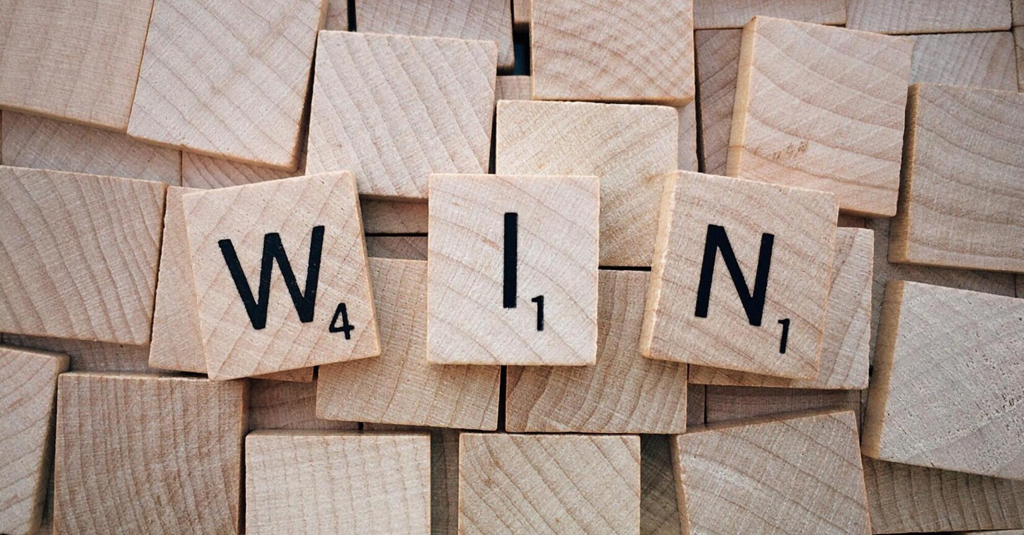 Word “Win” on wooden boards