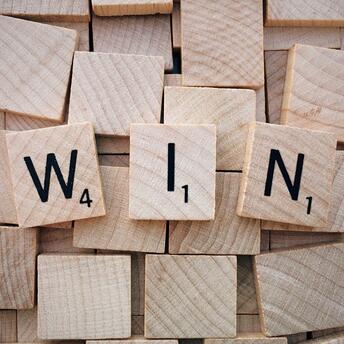 Word “Win” on wooden boards