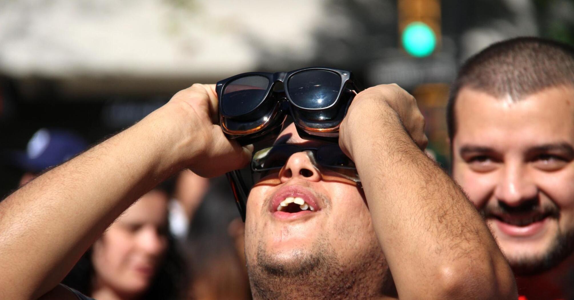 Man watching a solar eclipse
