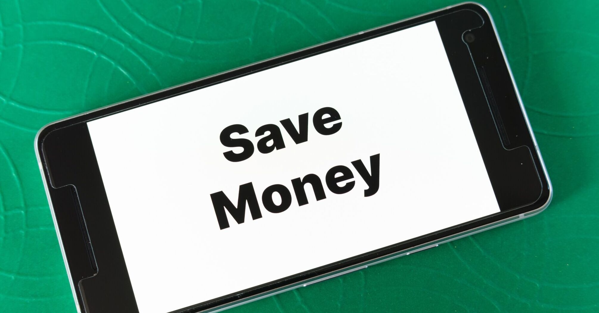 Smartphone screen displaying the words 'Save Money' on a green textured background