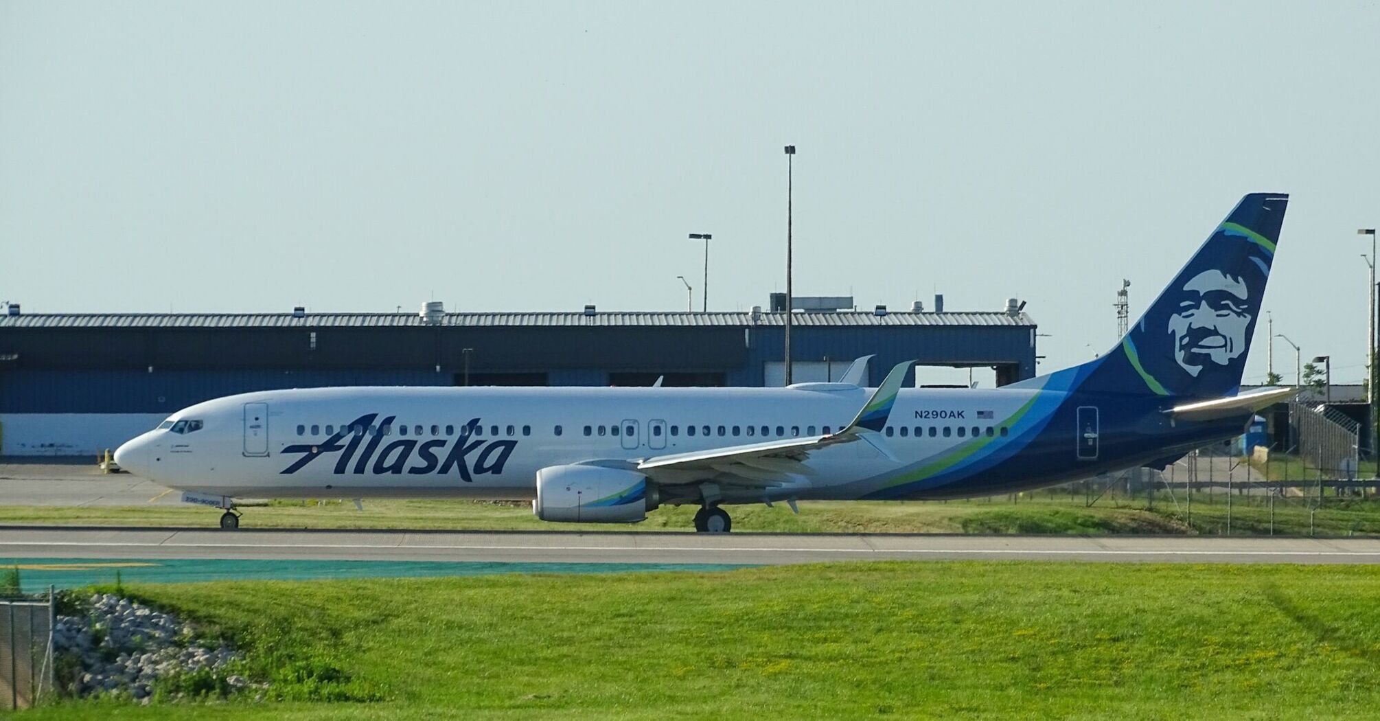 An Alaska Airlines on the runway with the airline's distinctive blue