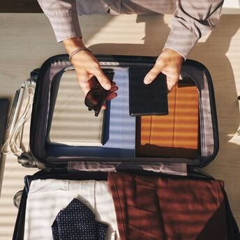 Which electronic devices can be carried in checked baggage during air travel