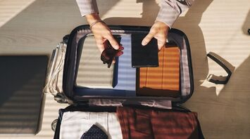 Which electronic devices can be carried in checked baggage during air travel