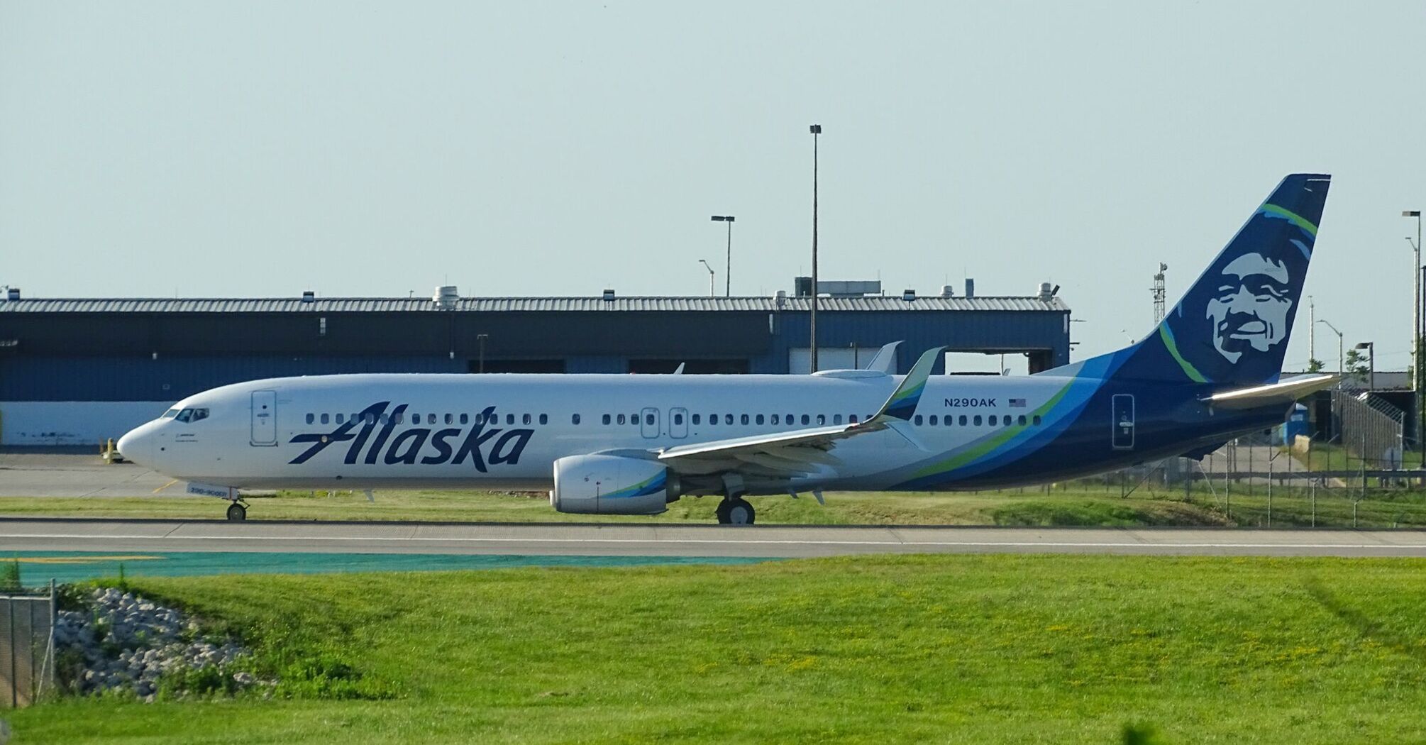 Alaska Airlines plane on the taxiway with the company’s distinctive blue and green livery