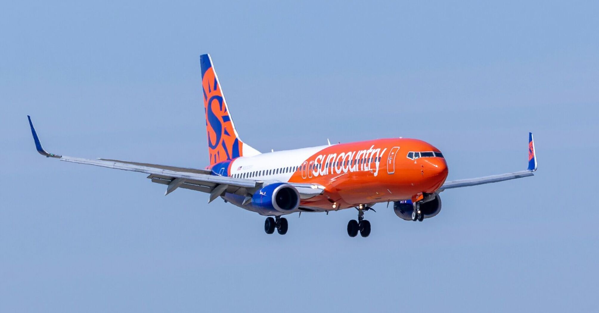 Sun Country Airlines plane flying in the sky