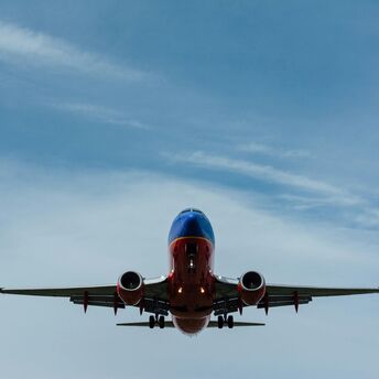 Blue and red airplane on sky