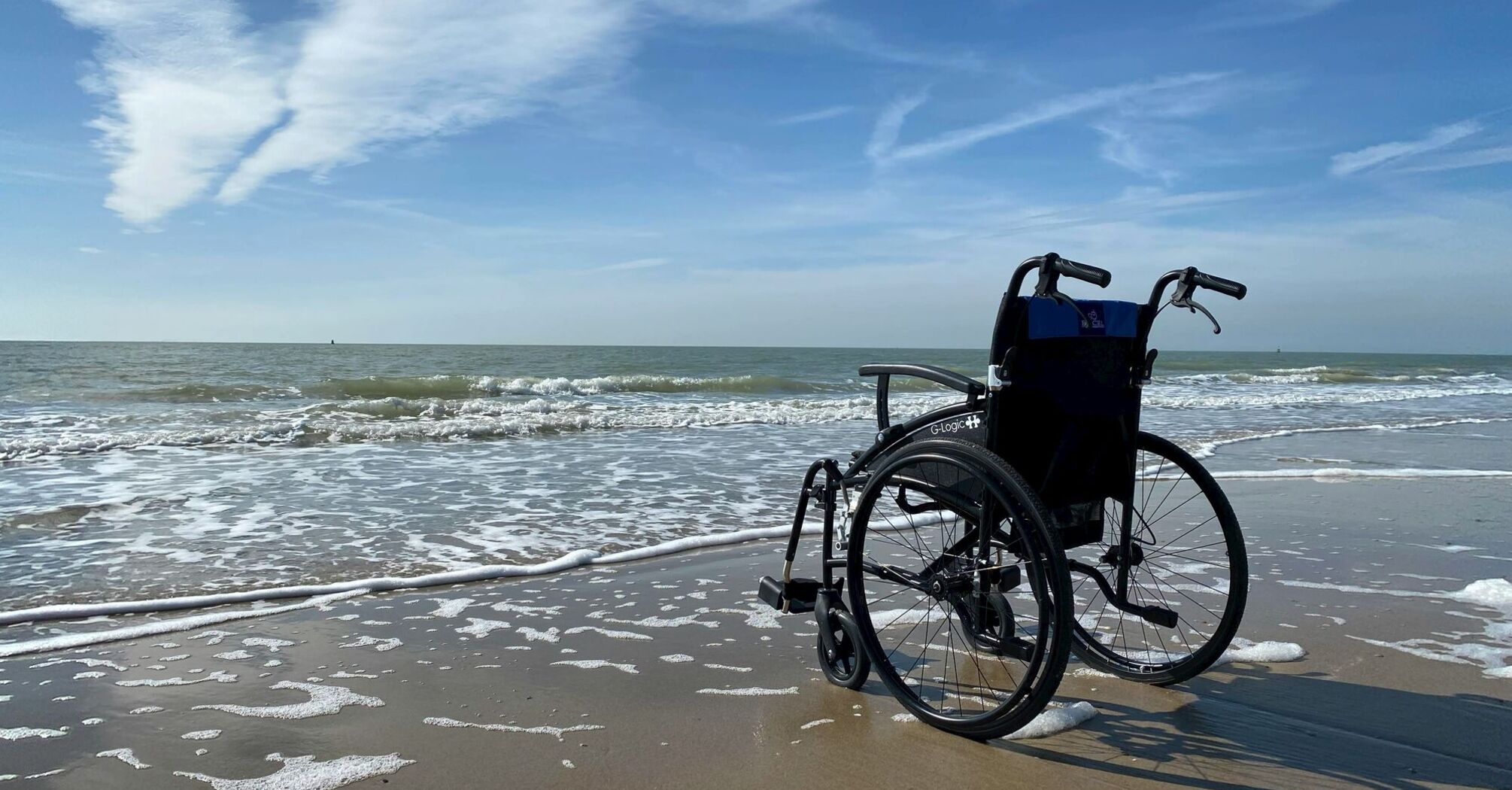 Black and gray wheelchair on beach during daytime