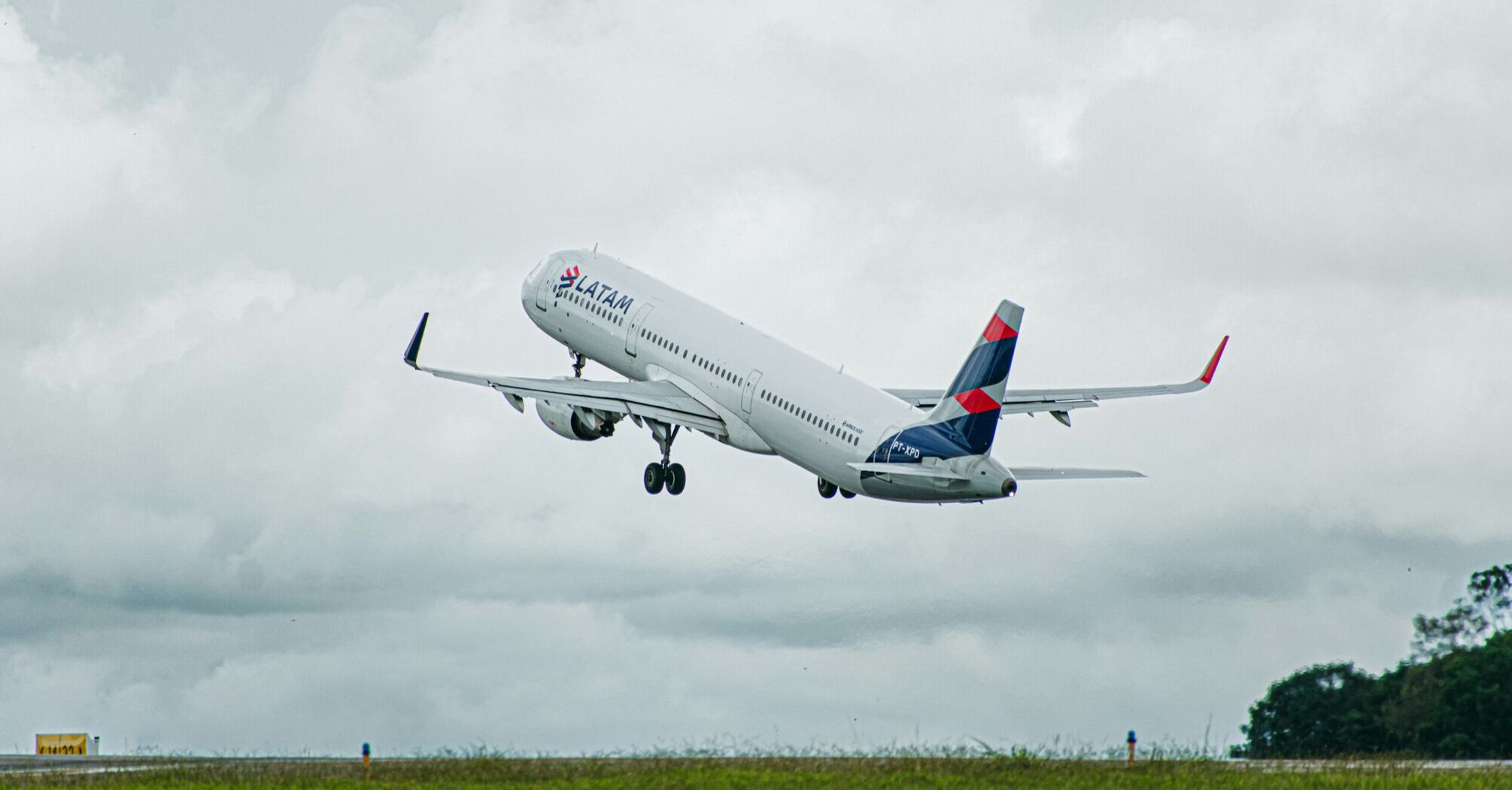 A large jetliner flying through a cloudy sky