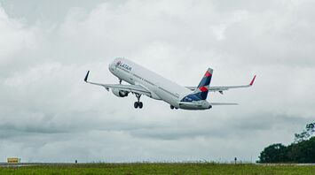 A large jetliner flying through a cloudy sky