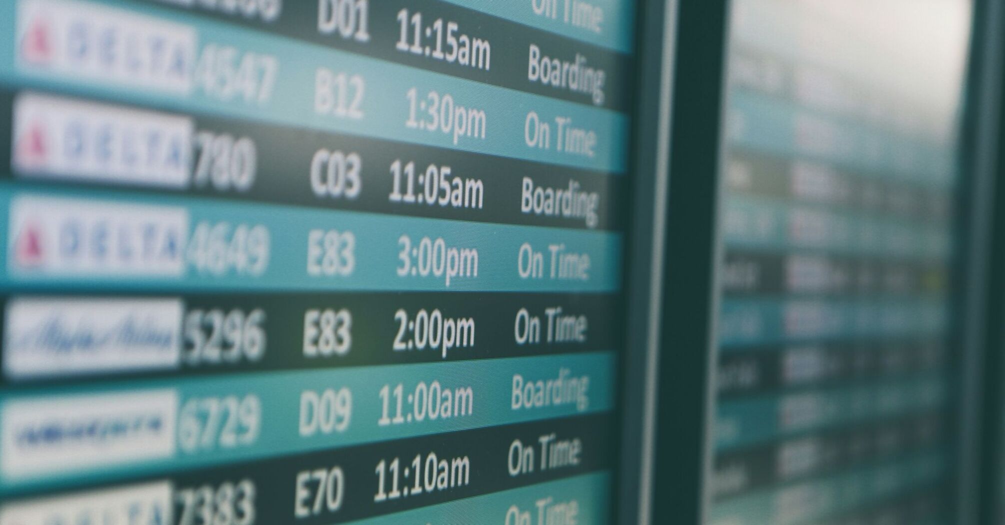Airport departures timetable showing delta and alaska airlines flights on time and boarding