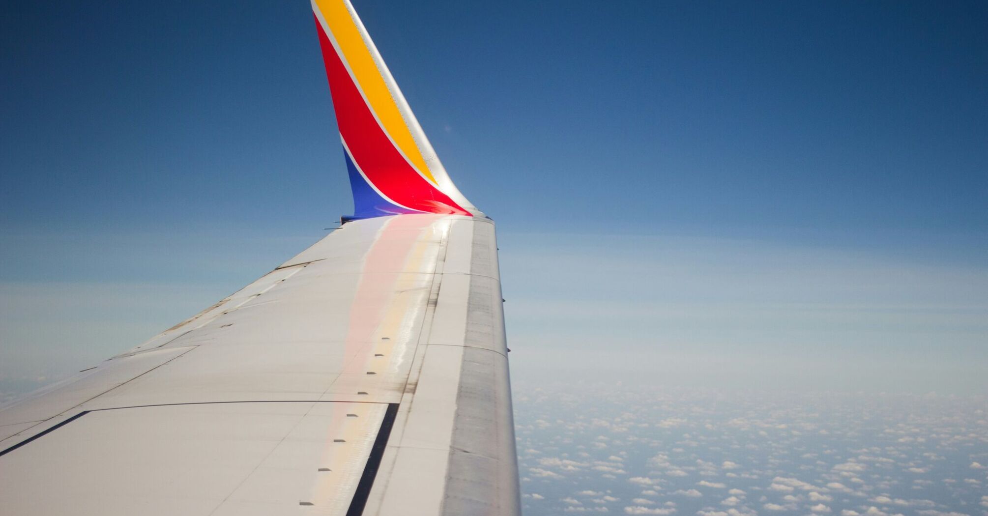 Wing of a Southwest Airlines plane against a clear blue sky