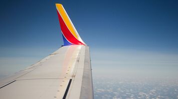 Wing of a Southwest Airlines plane against a clear blue sky