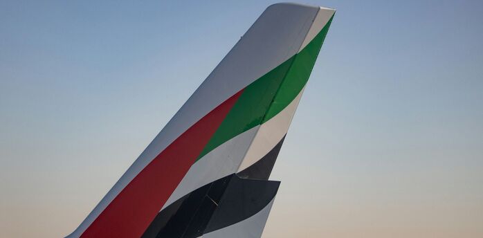 Tail fins of Emirates aircraft on tarmac