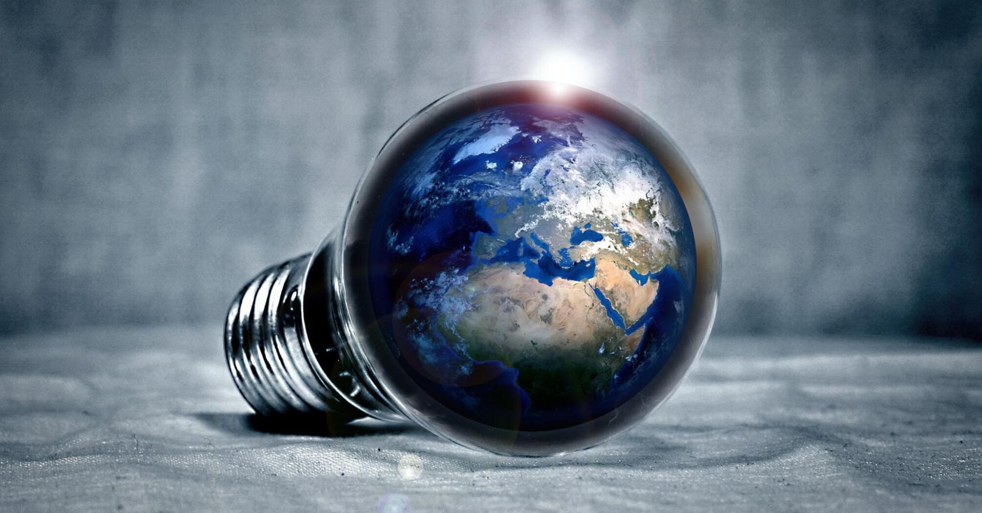 Ecology clean green planet pictured in a light bulb
