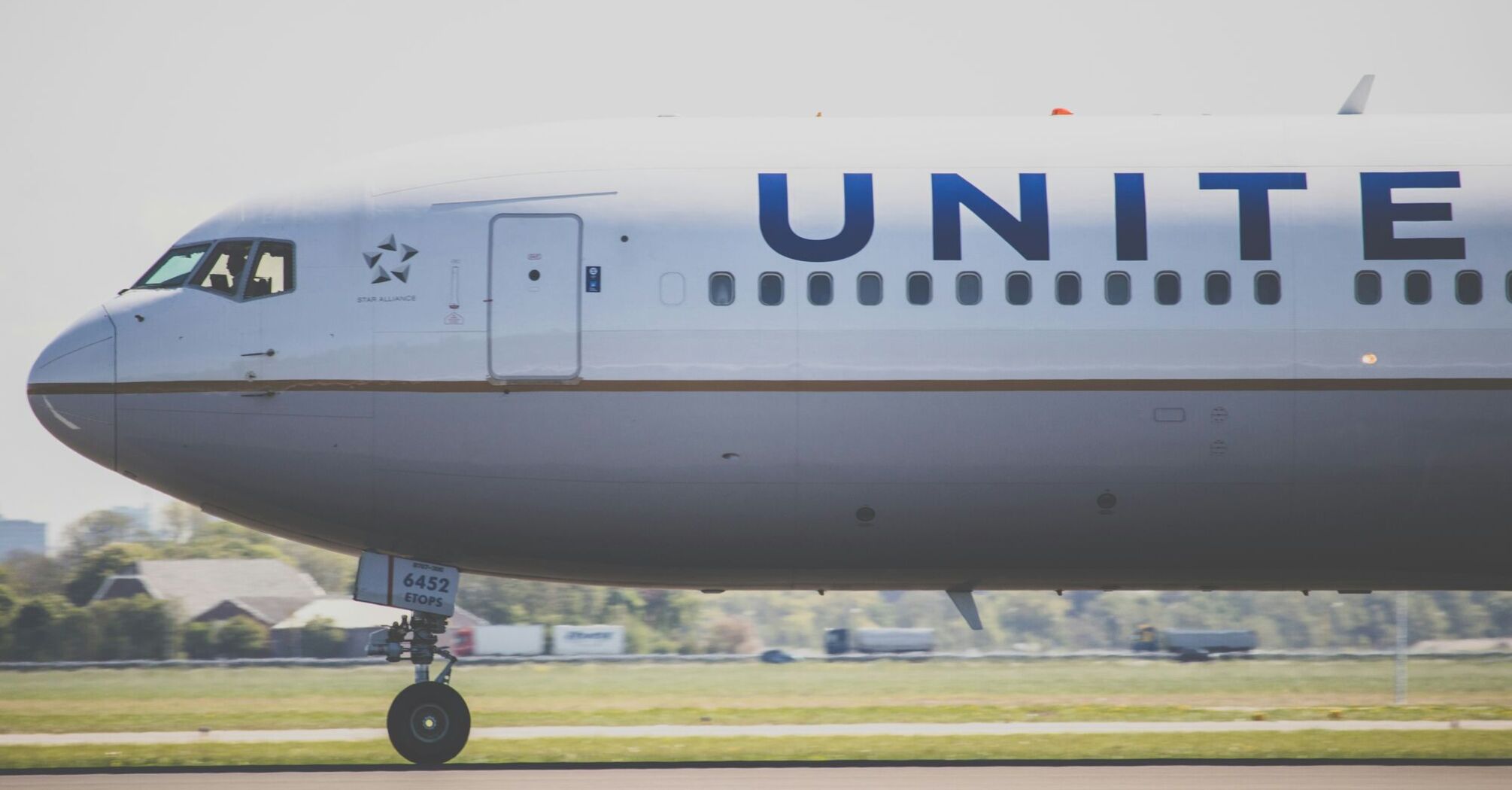 United Airlines jet taxiing on runway