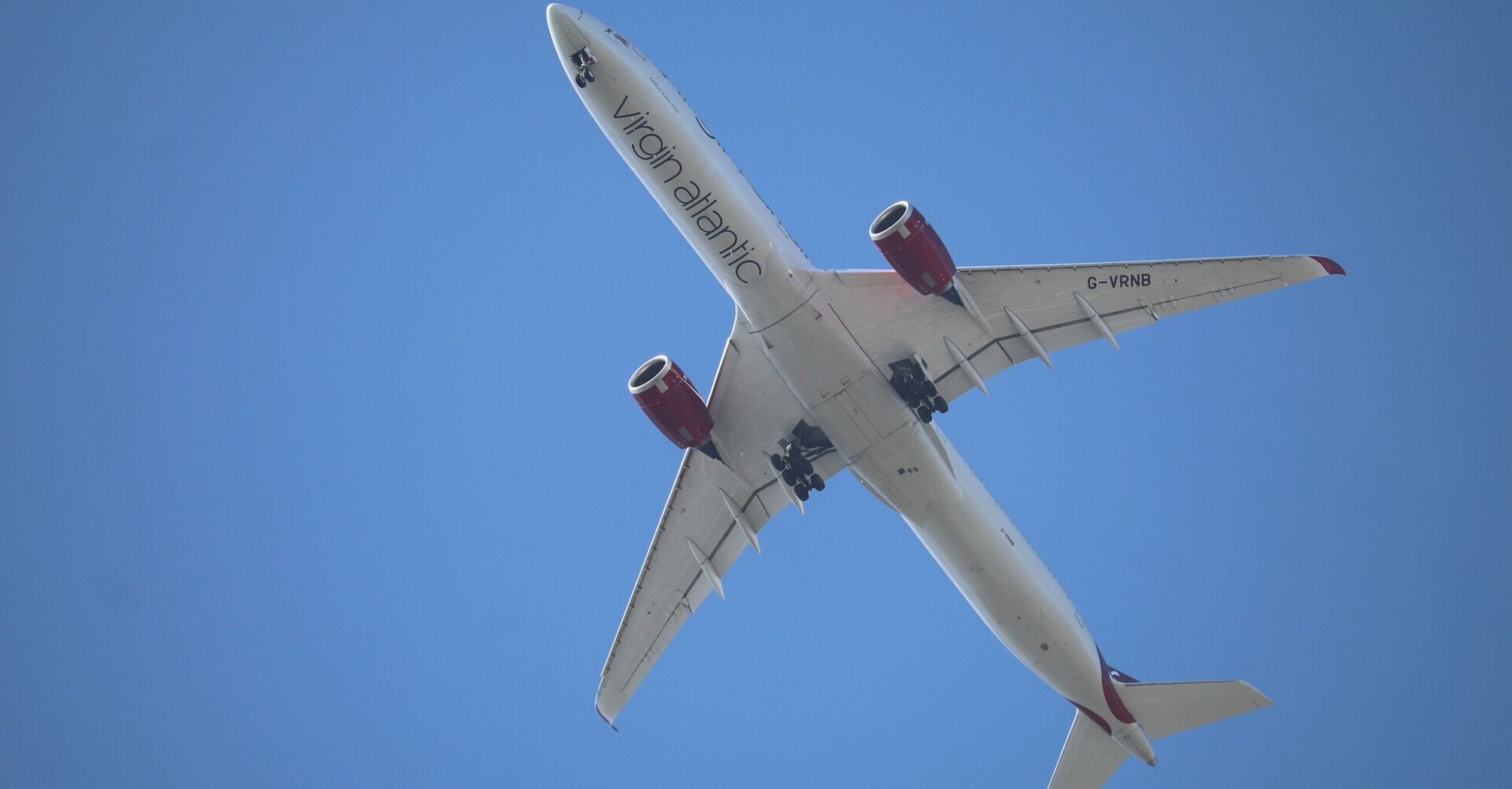Overhead view of a Virgin Atlantic Airbus A330 in flight against a clear blue sky