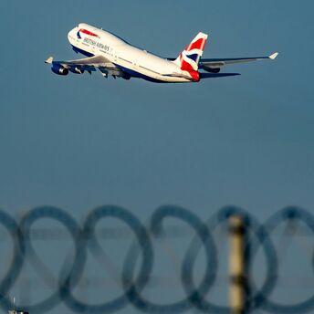 White and red air plane in mid air during daytime