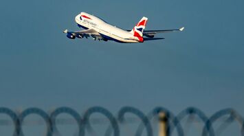 White and red air plane in mid air during daytime