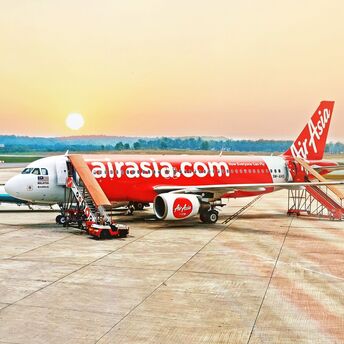 AirAsia airplane on the tarmac at sunset 