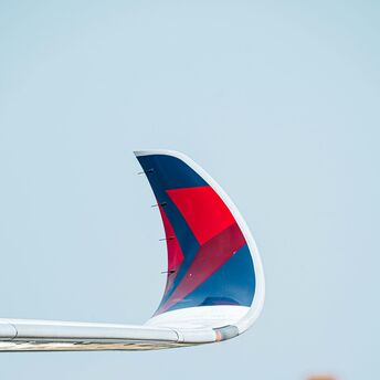 The wing end of an airplane that is flying in the sky