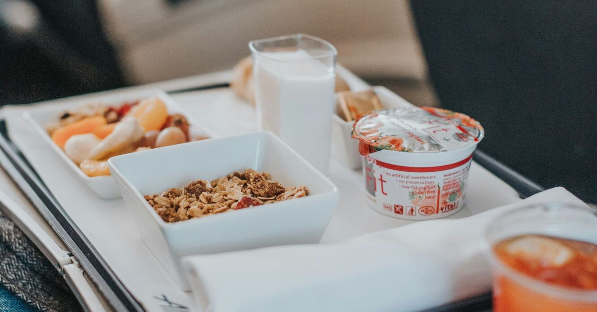 Inflight tray table with a breakfast meal and beverage