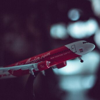 A model airplane of AirAsia with a blurred background