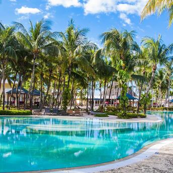 Pool near palm trees with houses