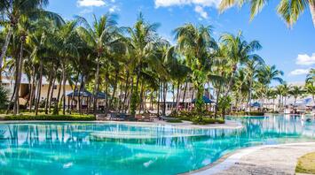 Pool near palm trees with houses