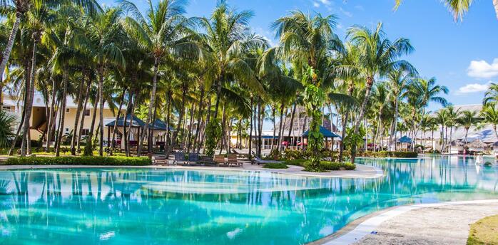 Pool near palm trees with houses