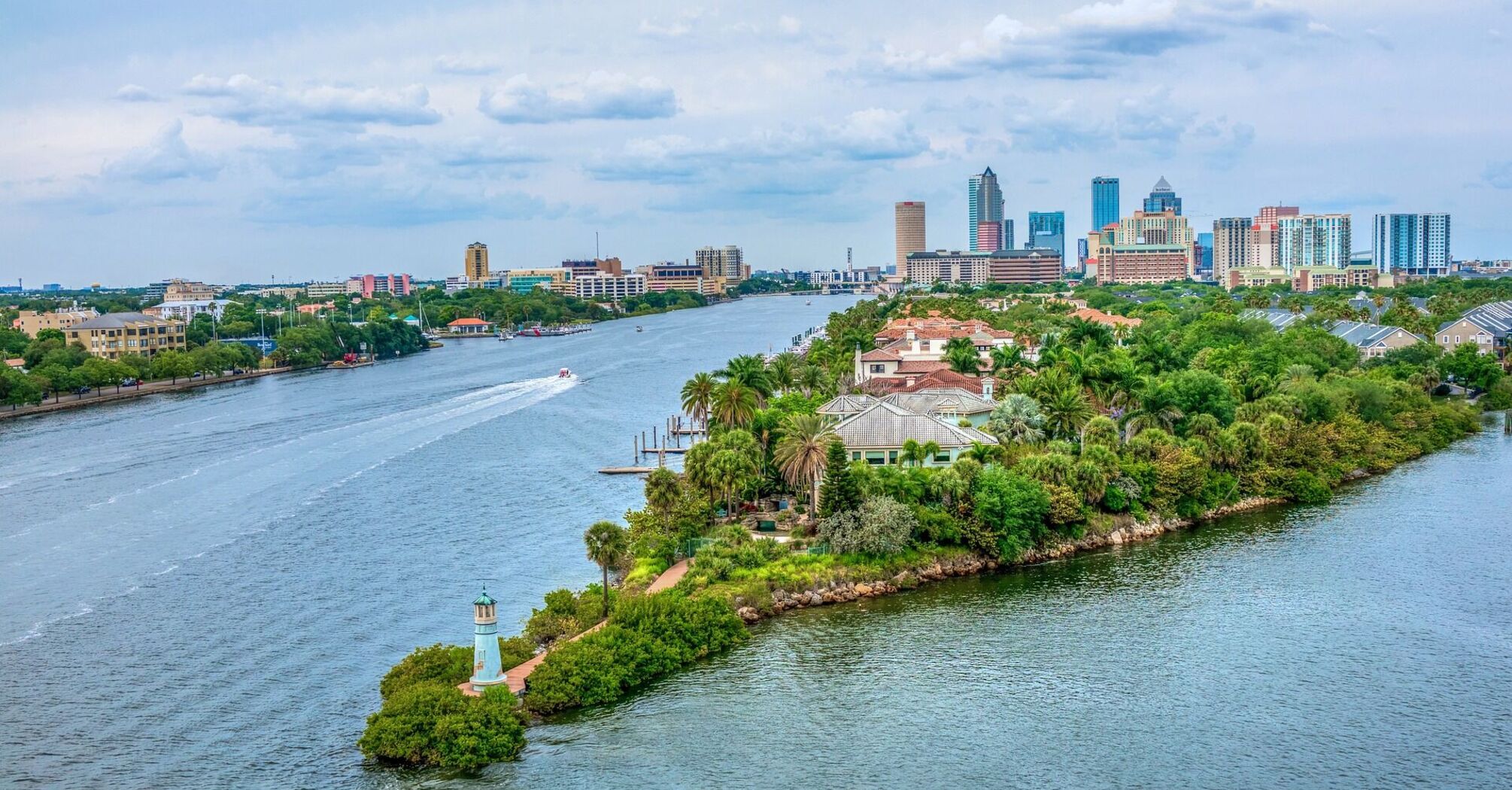 Aerial view of Tampa with riverfront, lush greenery, and city skyline