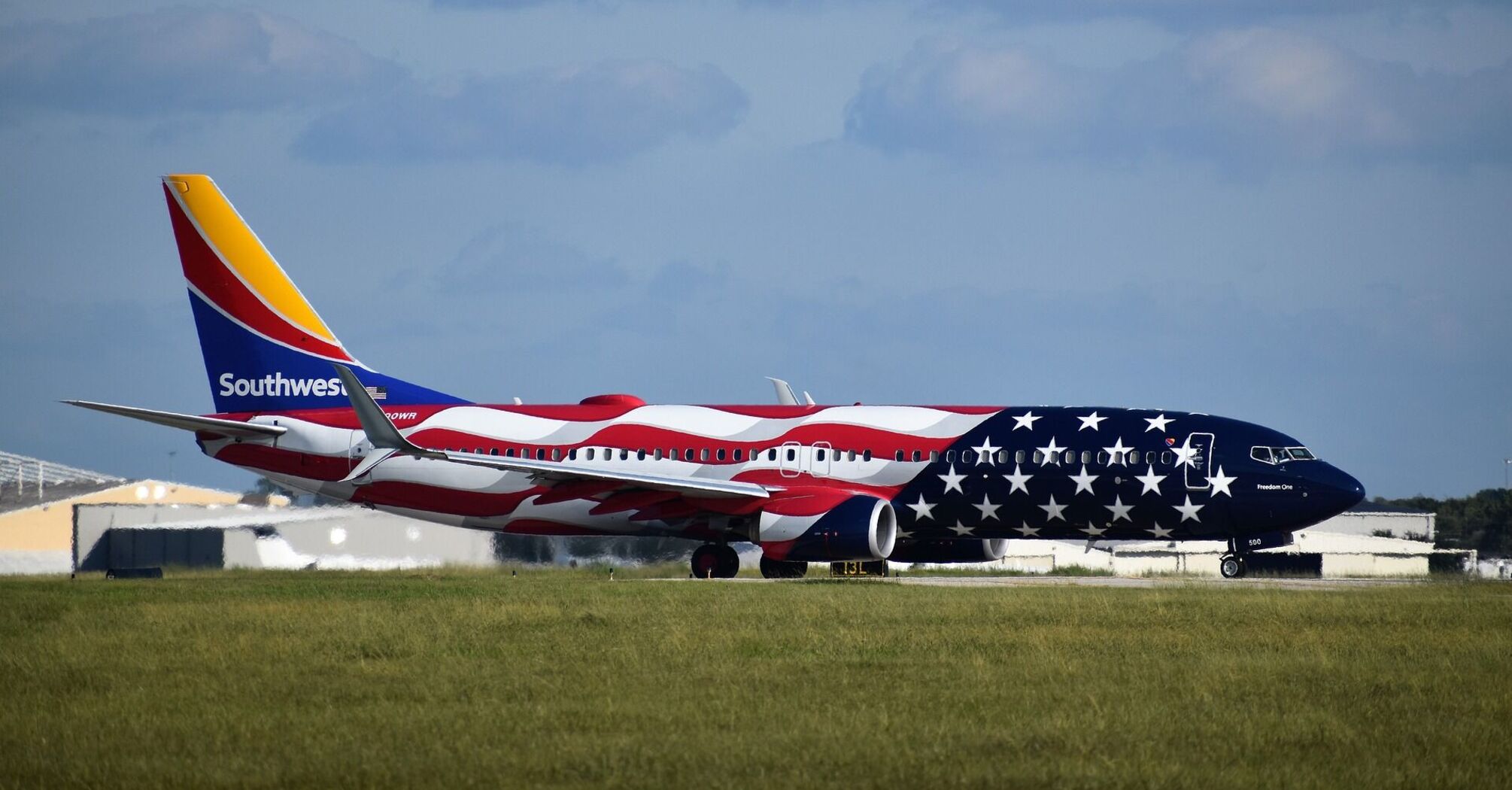 Southwest Airlines plane with a special livery featuring the American flag on its fuselage on the tarmac
