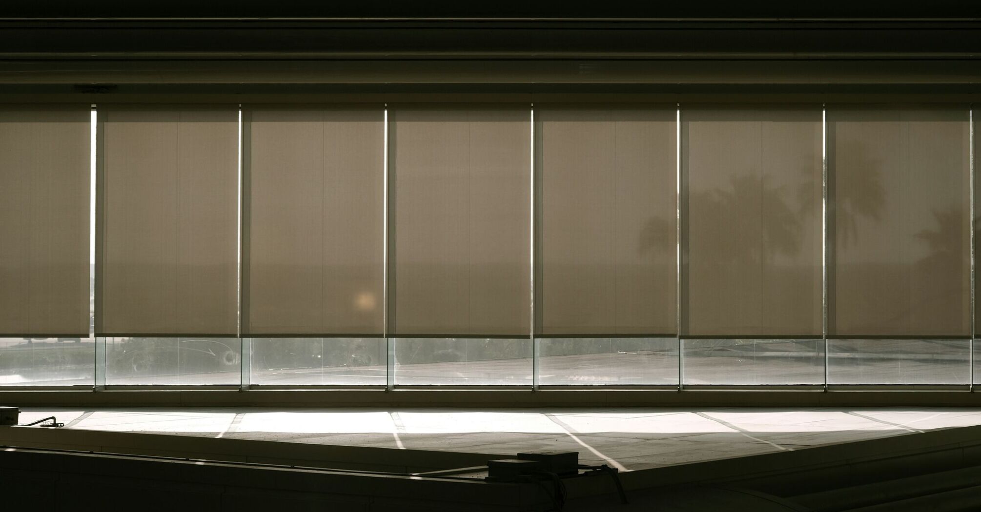 A window with blinds in a dark room
