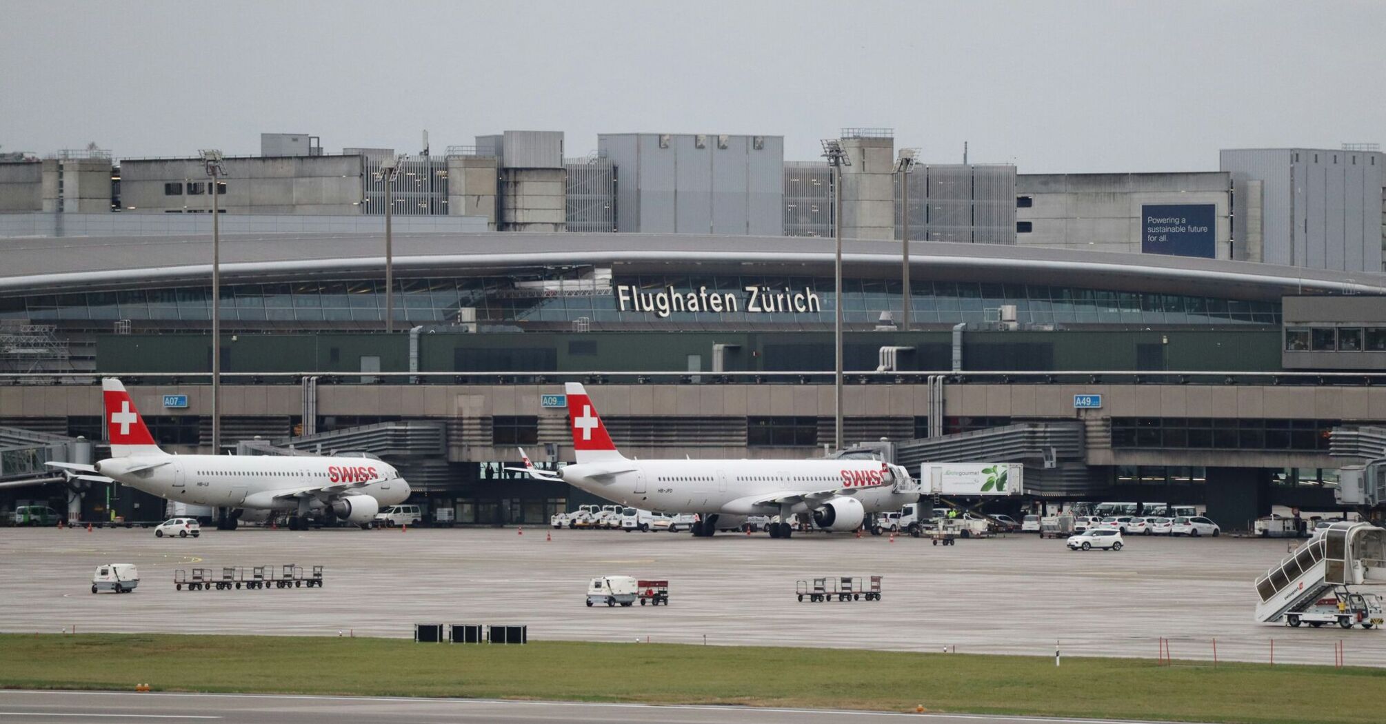 A couple of airplanes that are in Zurich Airport