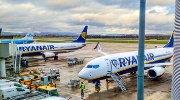 Ryanair and KLM aircraft parked at airport gates with ground service equipment