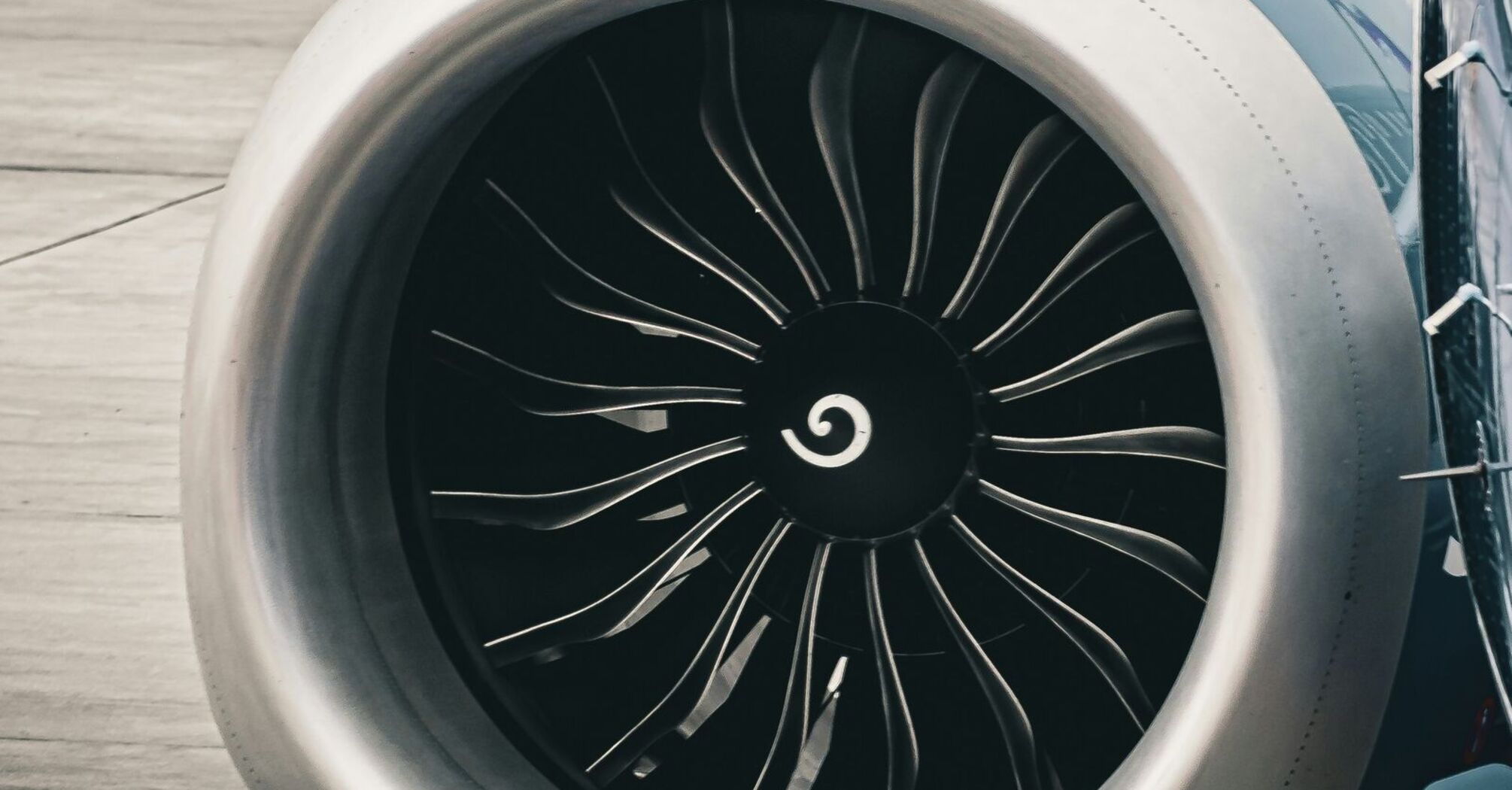 A close up of a jet engine on a runway