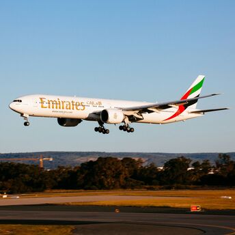 Emirates Boeing 777-300ER aircraft landing on the runway during the daytime