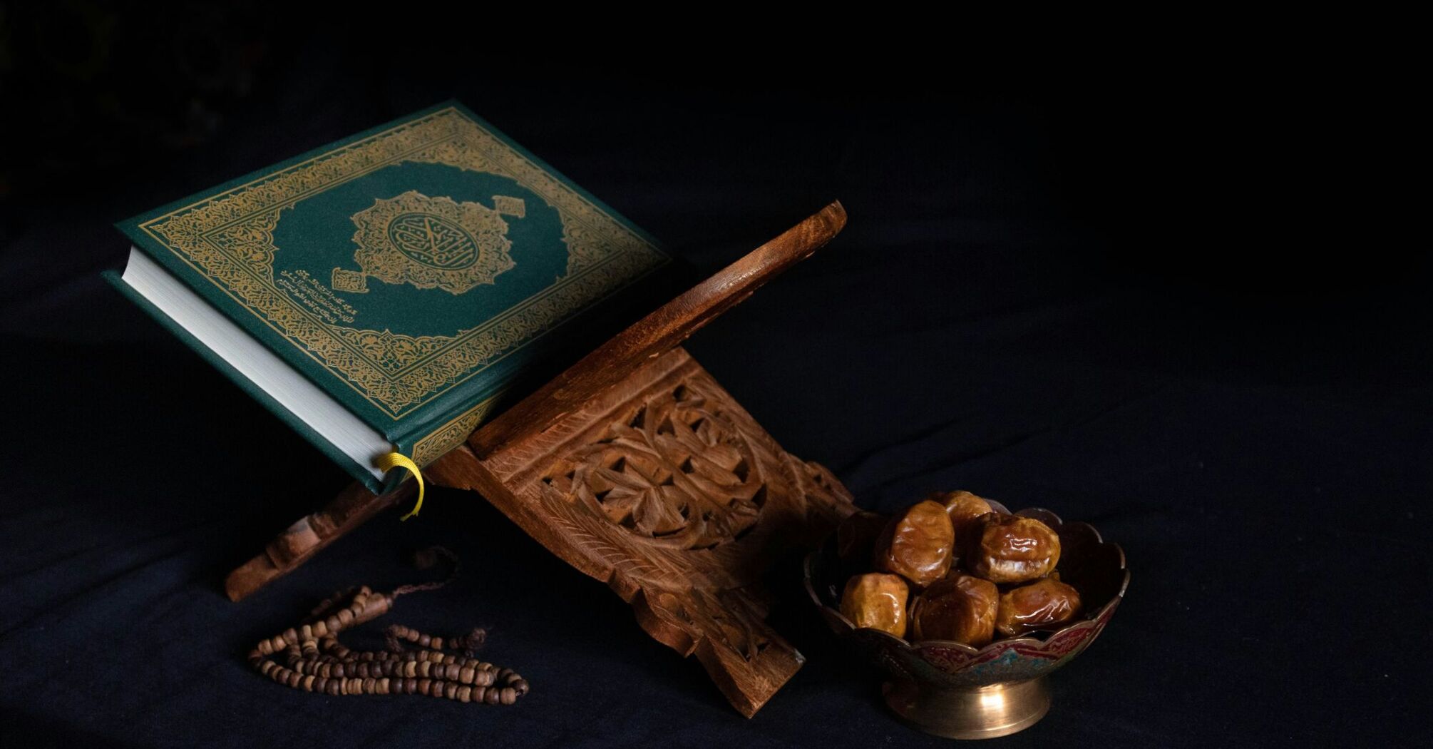 Green book beside brown wooden stick