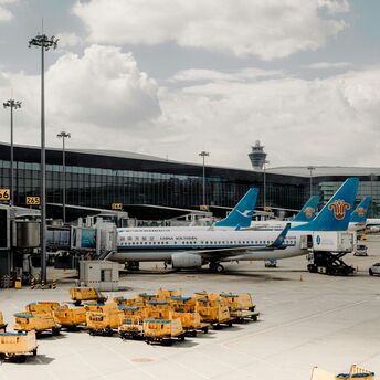 a-group-of-airplanes-parked-at-an-airport