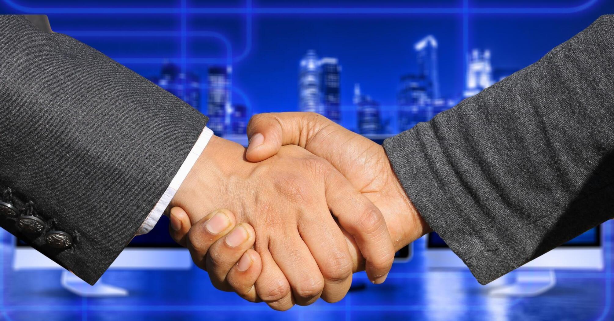 Shaking hands of two people in suits