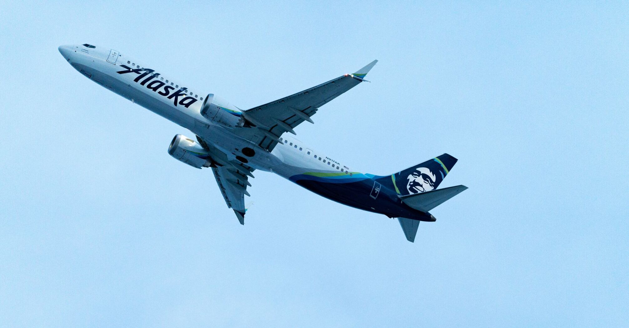 A large passenger jet flying through a blue sky