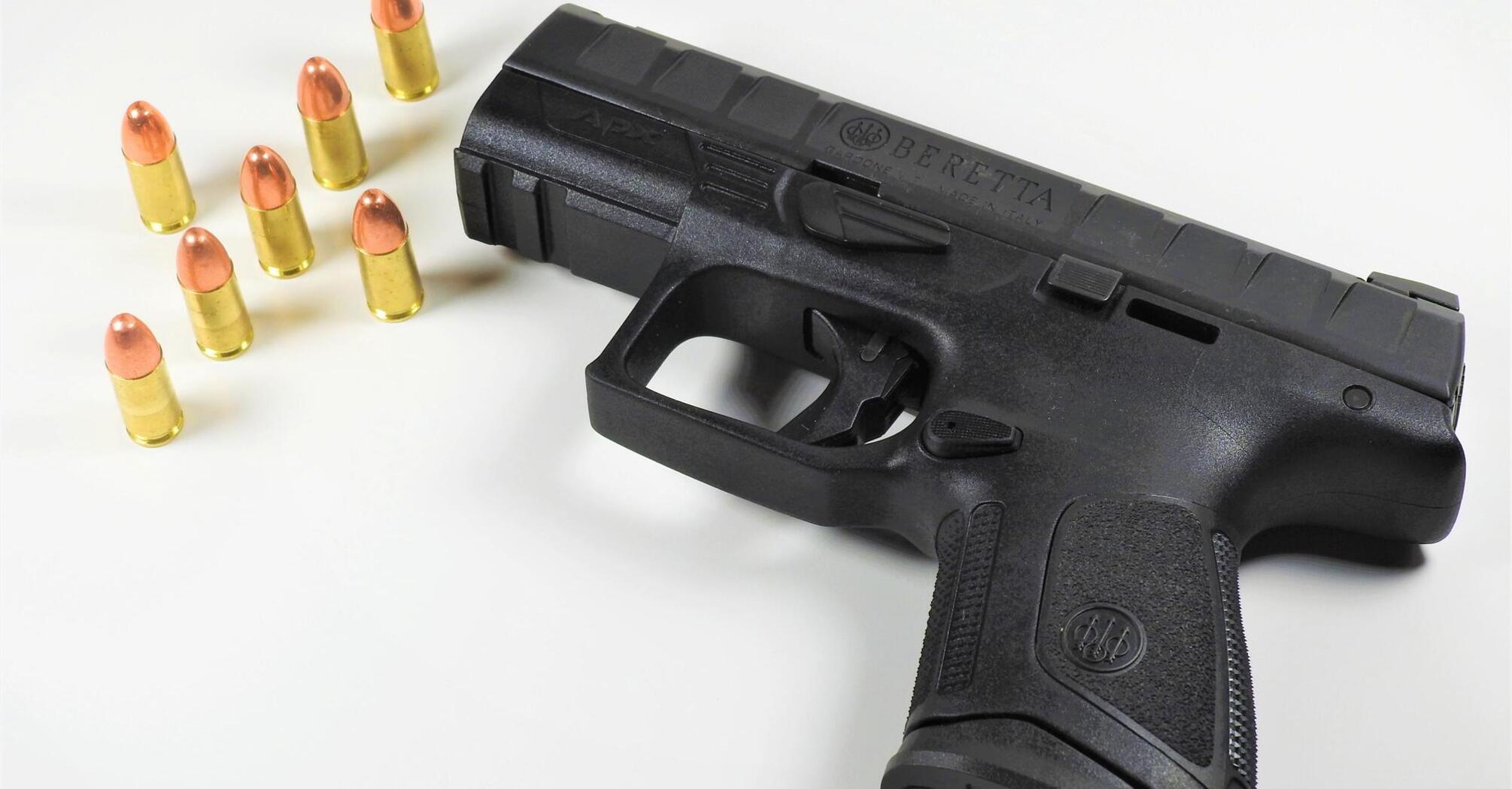 Loaded black handgun with bullets