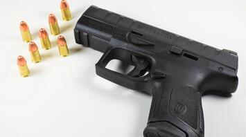 Loaded black handgun with bullets