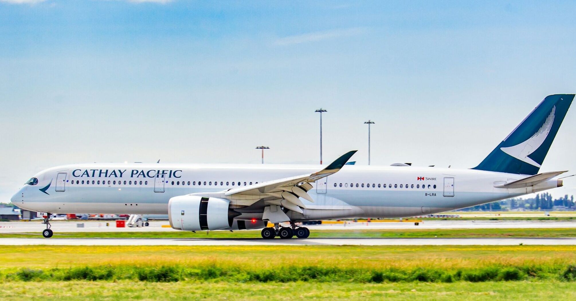 Cathay Pacific aircraft on runway in clear weather